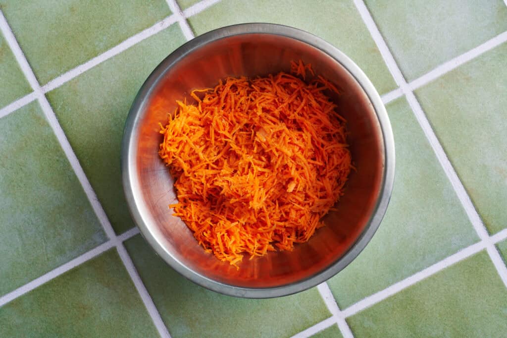 shredded carrots in a metal bowl