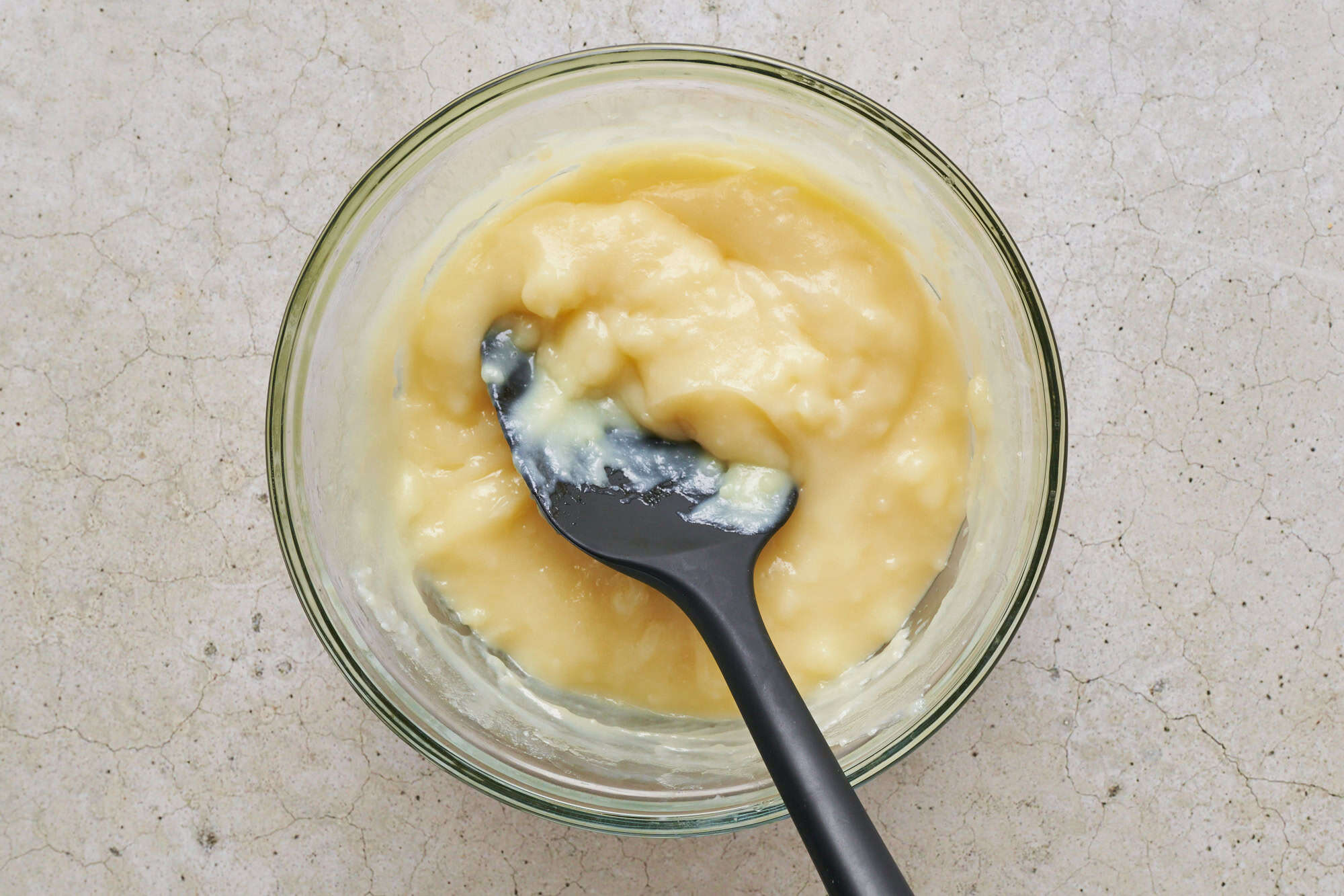 the base of the frosting once it's thickened in a small glass bowl with a silicone spatula