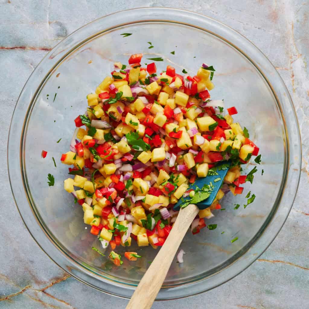 the salsa mixed up in a clear bowl with a spatula