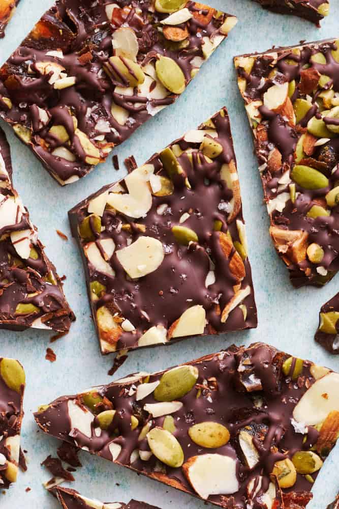 overhead view of dark chocolate bark with dates, almonds and pumpkin seeds