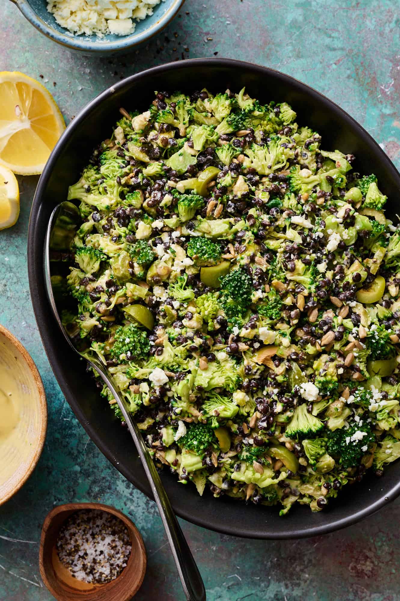 lentil broccoli salad in a large serving bowl with dressing on the side