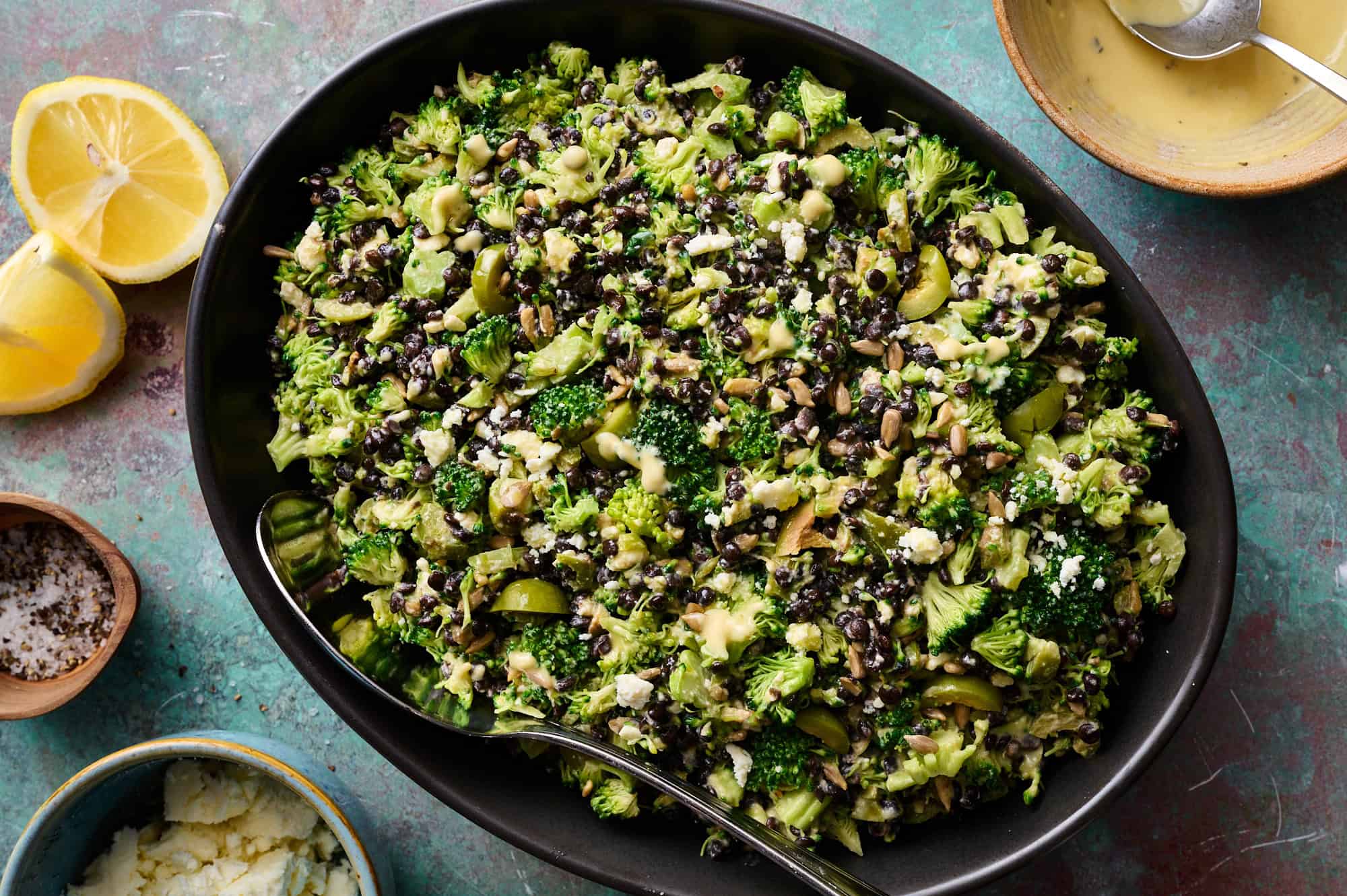 broccoli lentil salad in a large bowl ready to be served with extra dressing on the side