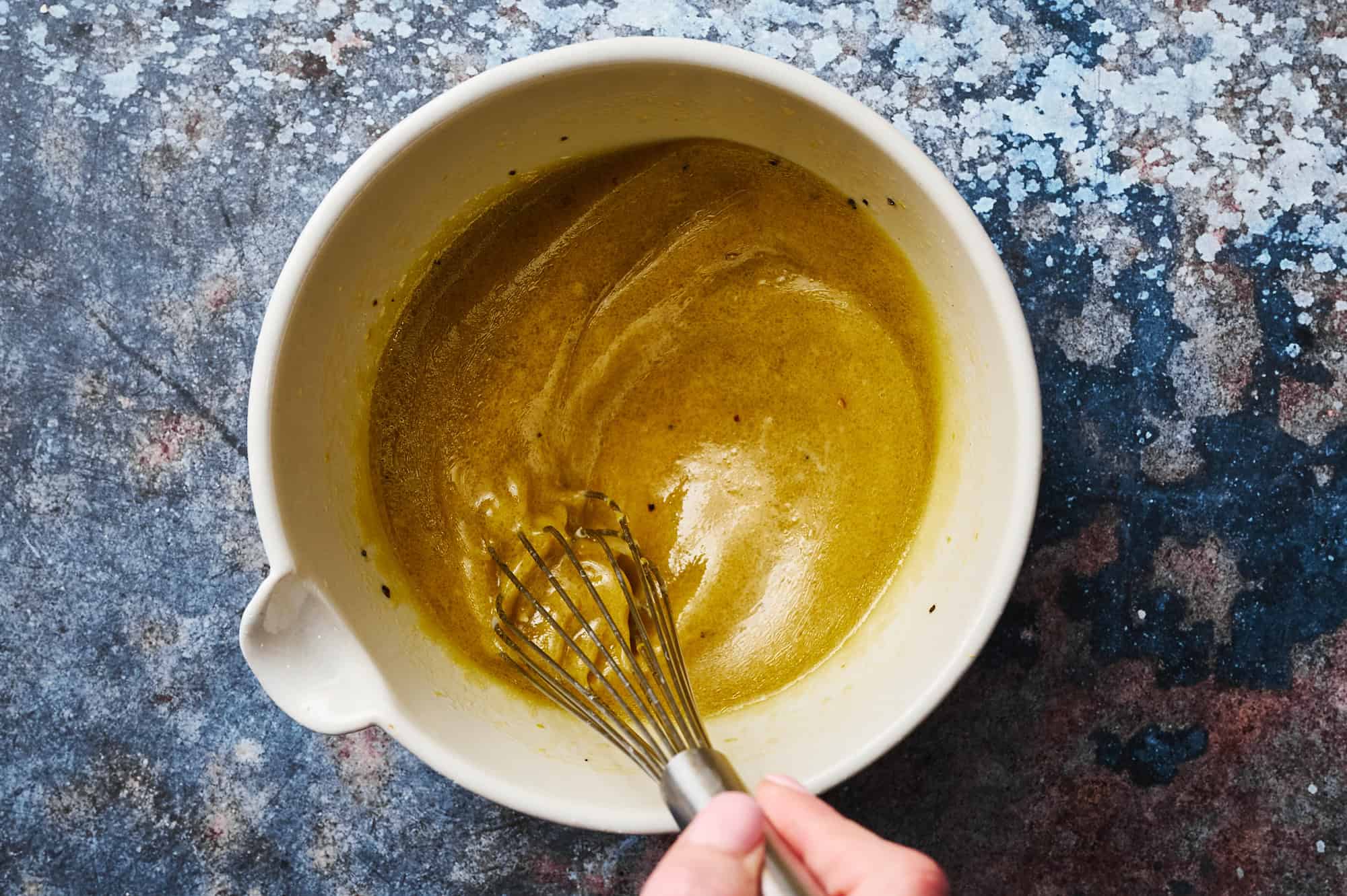 whisking together the dressing ingredients