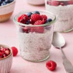 a chia yogurt parfait in a glass jar topped with berries