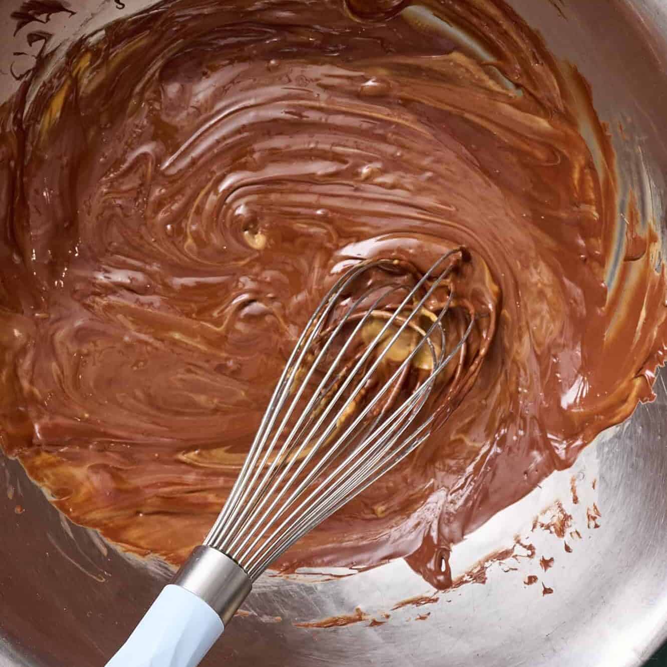 whisking the peanut butter into the chocolate in a large metal bowl