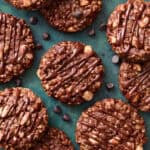 finished chocolate no bake rice Krispie cookies on a green background drizzled with chocolate