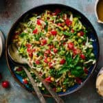 a large serving bowl filled with caprese chopped salad including mozzarella, basil and tomatoes