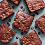 closeup of sliced brownies with chocolate chips scattered around