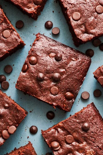 closeup of sliced brownies with chocolate chips scattered around