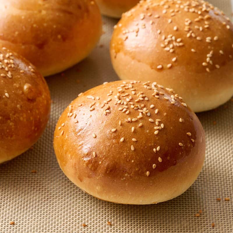 sourdough discard burger buns fresh out of the oven on a baking tray