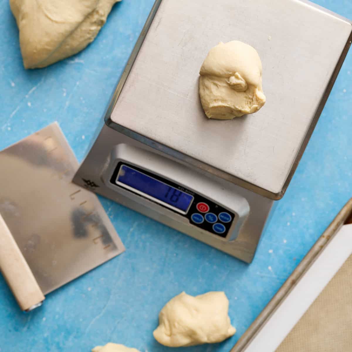 weighing dough balls on a kitchen scale