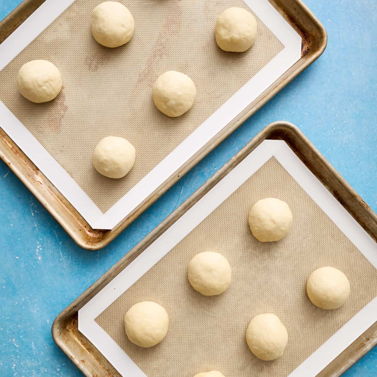 rolls on two baking trays with silicone liners