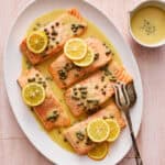 salmon piccata with capers and garnished with fresh lemon