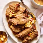 Slow Cooker Country Style Pork Ribs with Apple Gravy on a serving platter