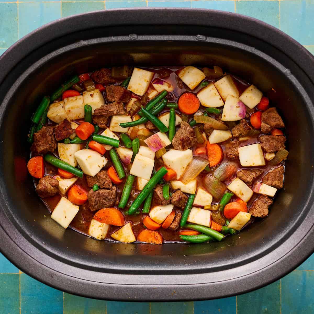 turnips, carrots and green beans added to the slow cooker for the second half of cooking