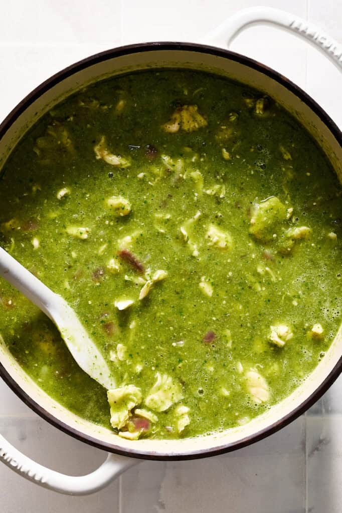 sauce added to a pot with simmering chicken