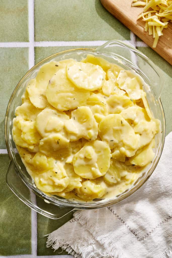potatoes tossed in the creamy sauce before being topped with cheese