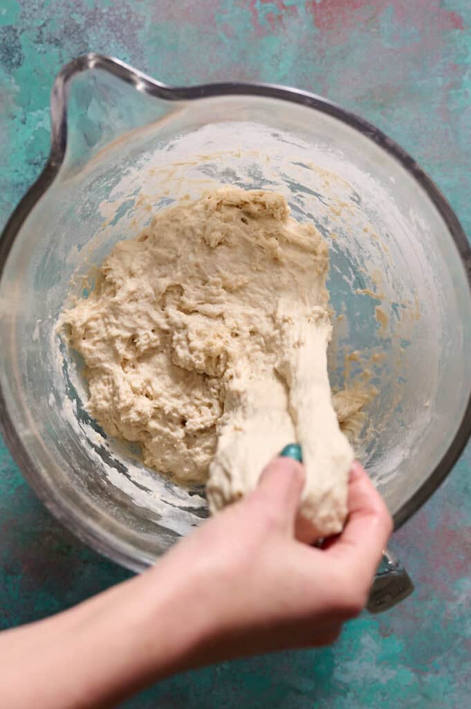 doing stretch and folds on artisan loaf of sourdough bread dough