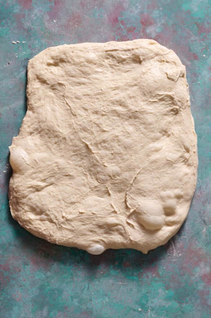 laying out the fermented dough in a sheet
