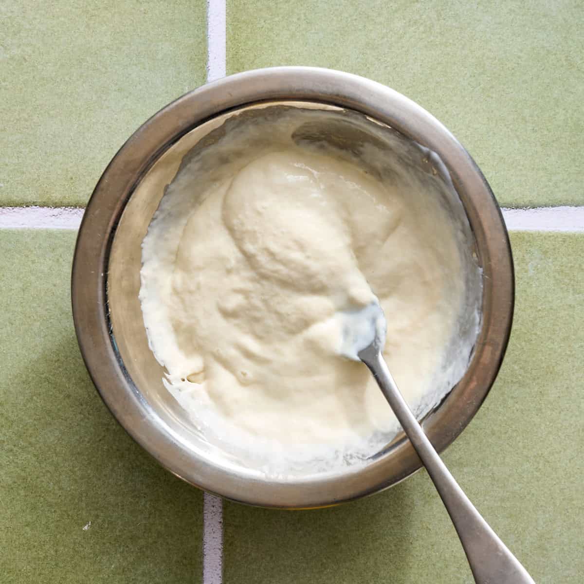 whisking the sourdough discard with yogurt