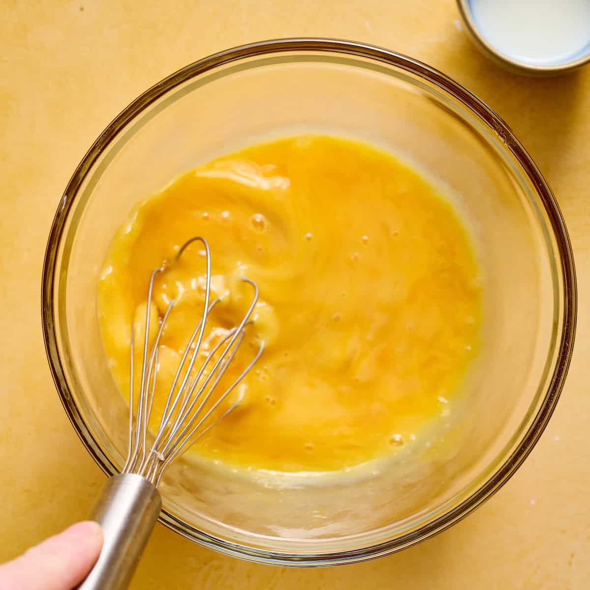 whisking eggs in a bowl