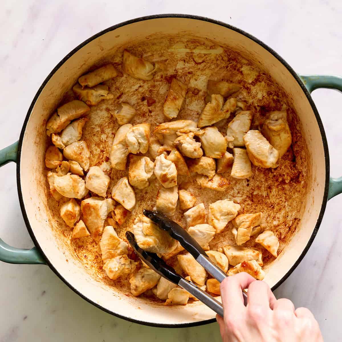 browning chicken in a large stock pot