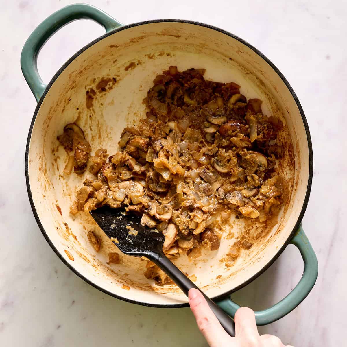 adding flour to the pot with the mushrooms onion and garlic to create a roux
