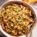 ramen noodle salad in a large serving bowl with tongs