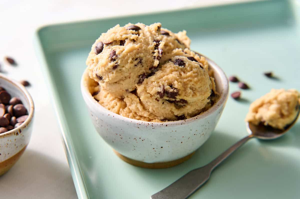 cottage cheese cookie dough scooped into a bowl with extra chocolate chips