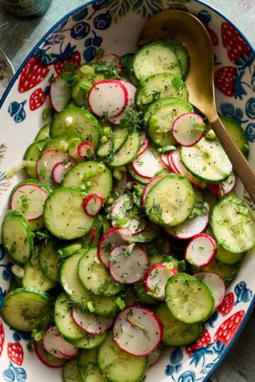 radish and cucumber salad tossed in a bowl