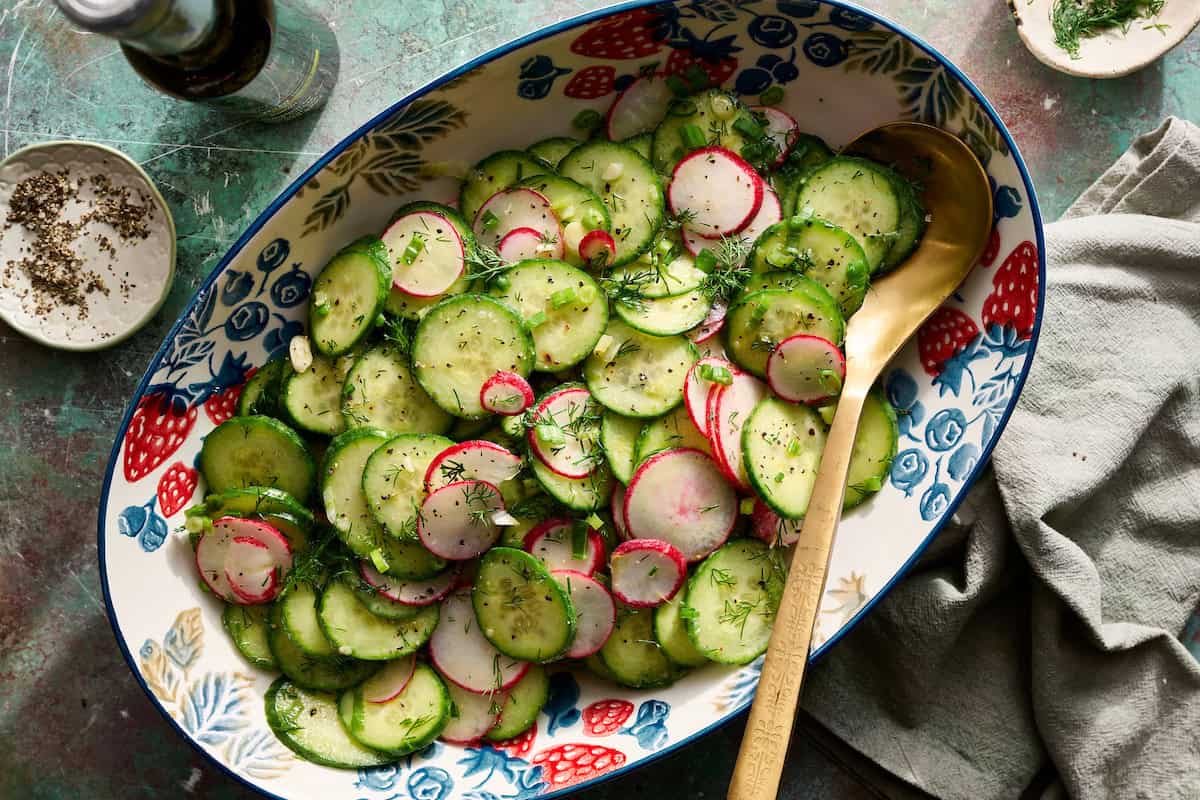radish and cucumber salad tossed in a bowl