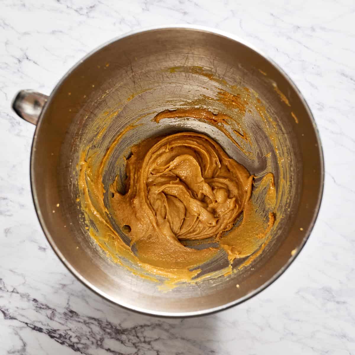 adding the eggs and vanilla to the wet ingredients in a bowl