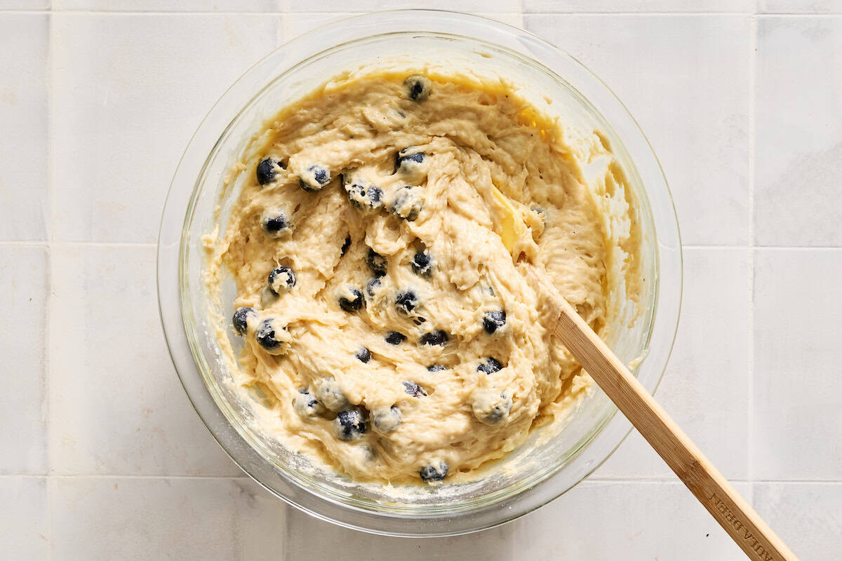 folding the blueberries into the muffin batter