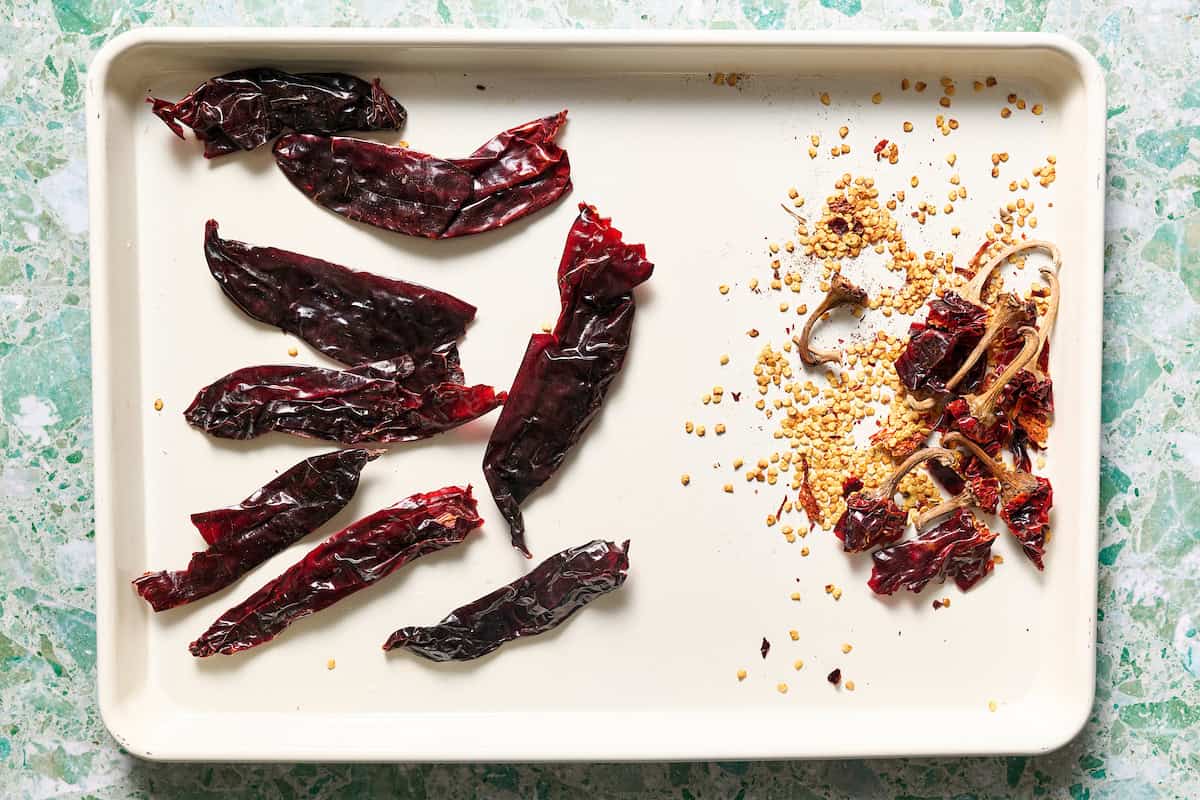 removing tops from the dried chilies