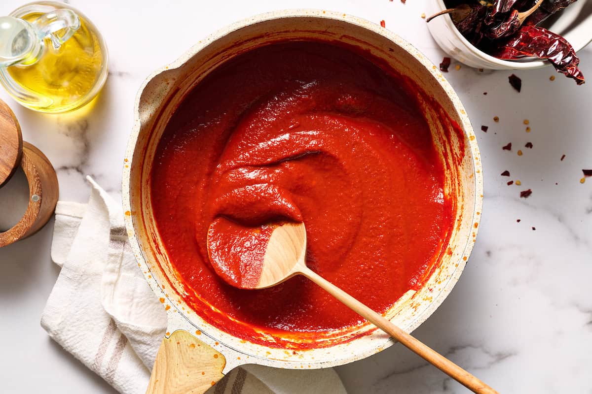 Homemade red sauce simmered in a saute pan, rich red color